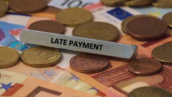 late payment sign on cash on coins SMEs